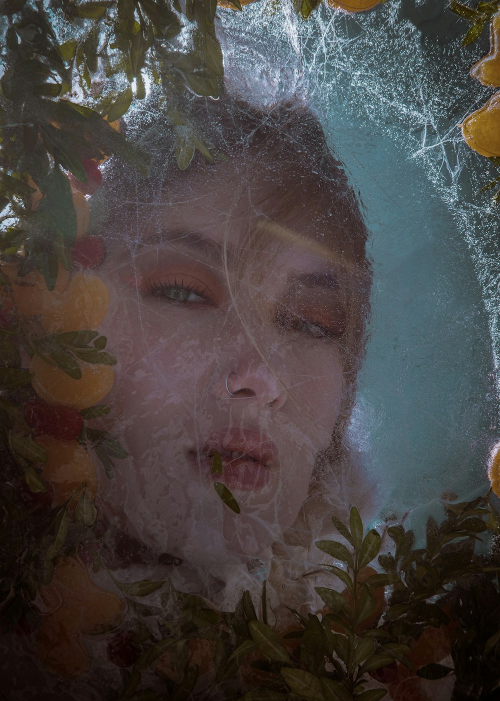 a woman is surrounded by fruit and leaves