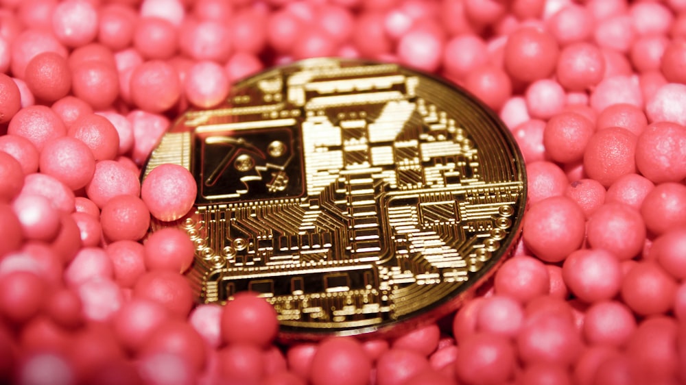 a close up of a coin surrounded by pink balls