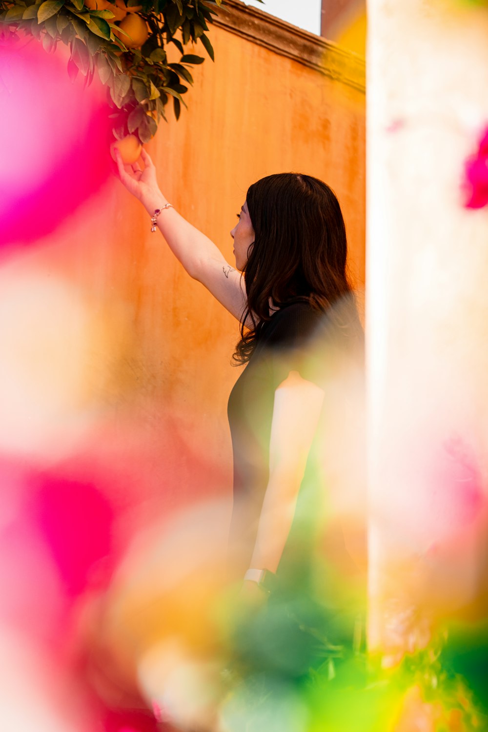 a woman in a black dress is pointing at something