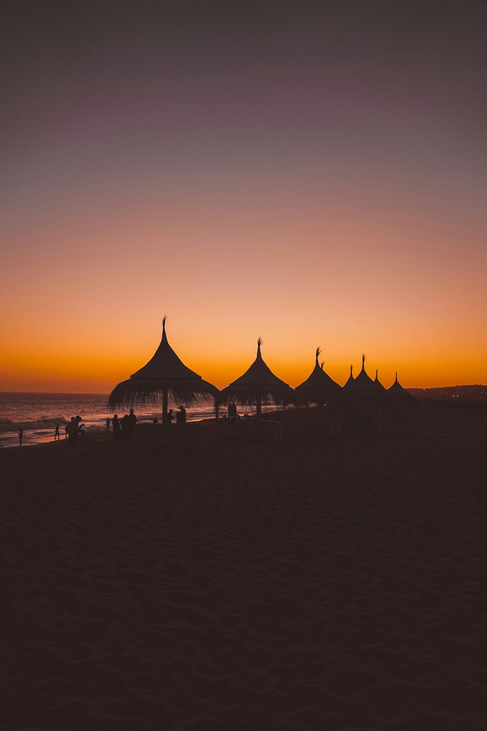 a group of tents sitting on top of a sandy beach