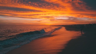 A vibrant sunset over a serene beach landscape.