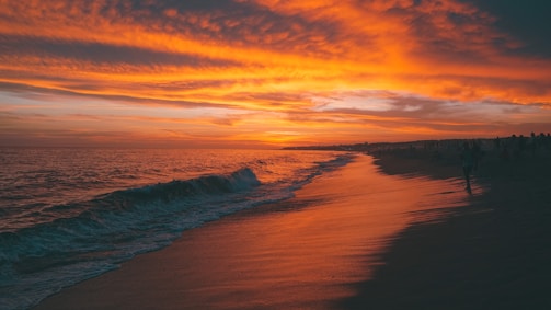 A vibrant sunset over a serene beach landscape.