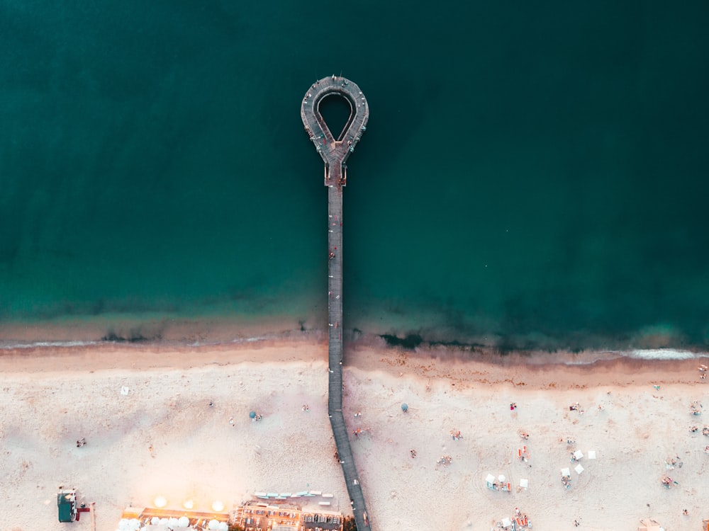 an aerial view of a beach with a light pole
