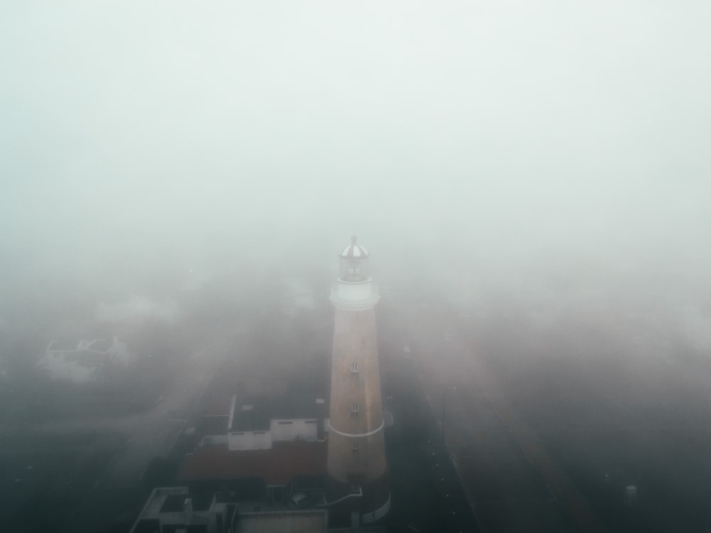 a light house in the middle of a foggy day