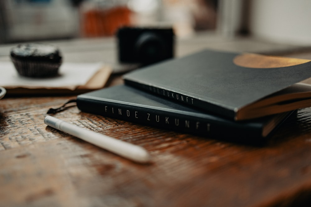 a couple of books sitting on top of a wooden table