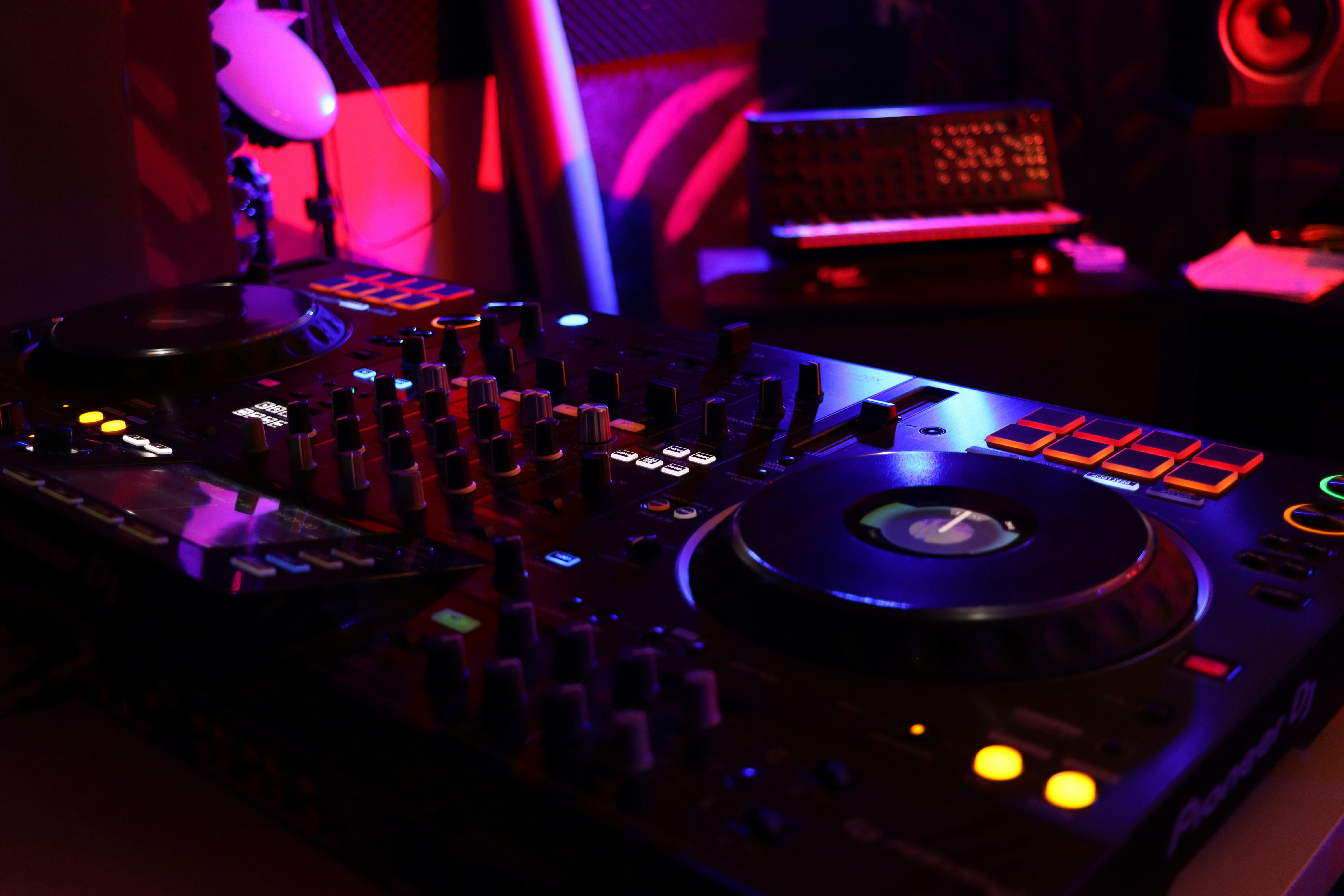 a dj's turntable in a dimly lit room