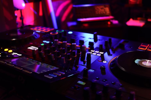 a dj mixing equipment in a dark room