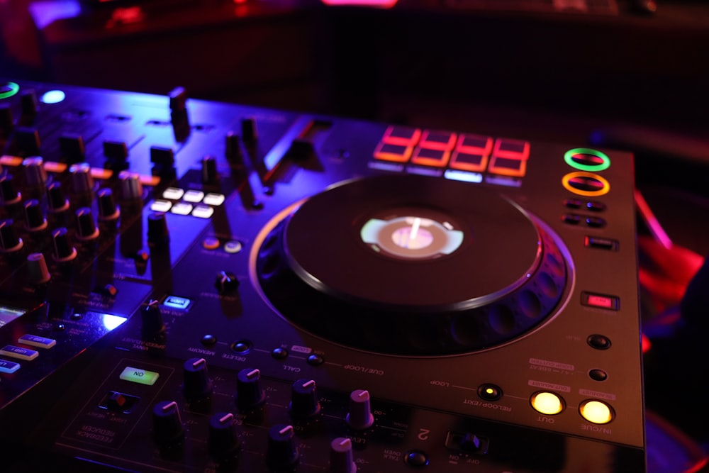 a dj's turntable and controller in a dark room