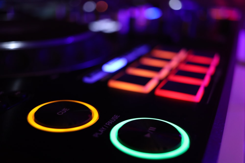 a close up of a computer keyboard with neon lights