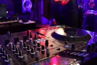 a dj mixing equipment in a dark room