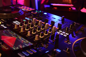 a dj mixing equipment in a dark room
