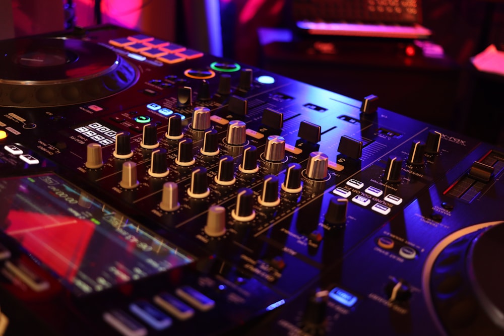a dj mixing equipment in a dark room