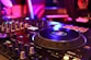 a close up of a dj's turntable in a nightclub