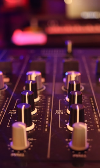 a close up of a sound board in a recording studio