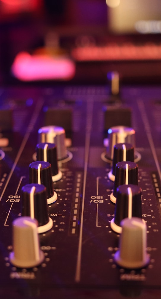 a close up of a sound board in a recording studio