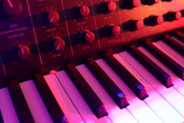 a close up of a keyboard with many knobs