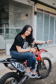 a woman sitting on top of a dirt bike