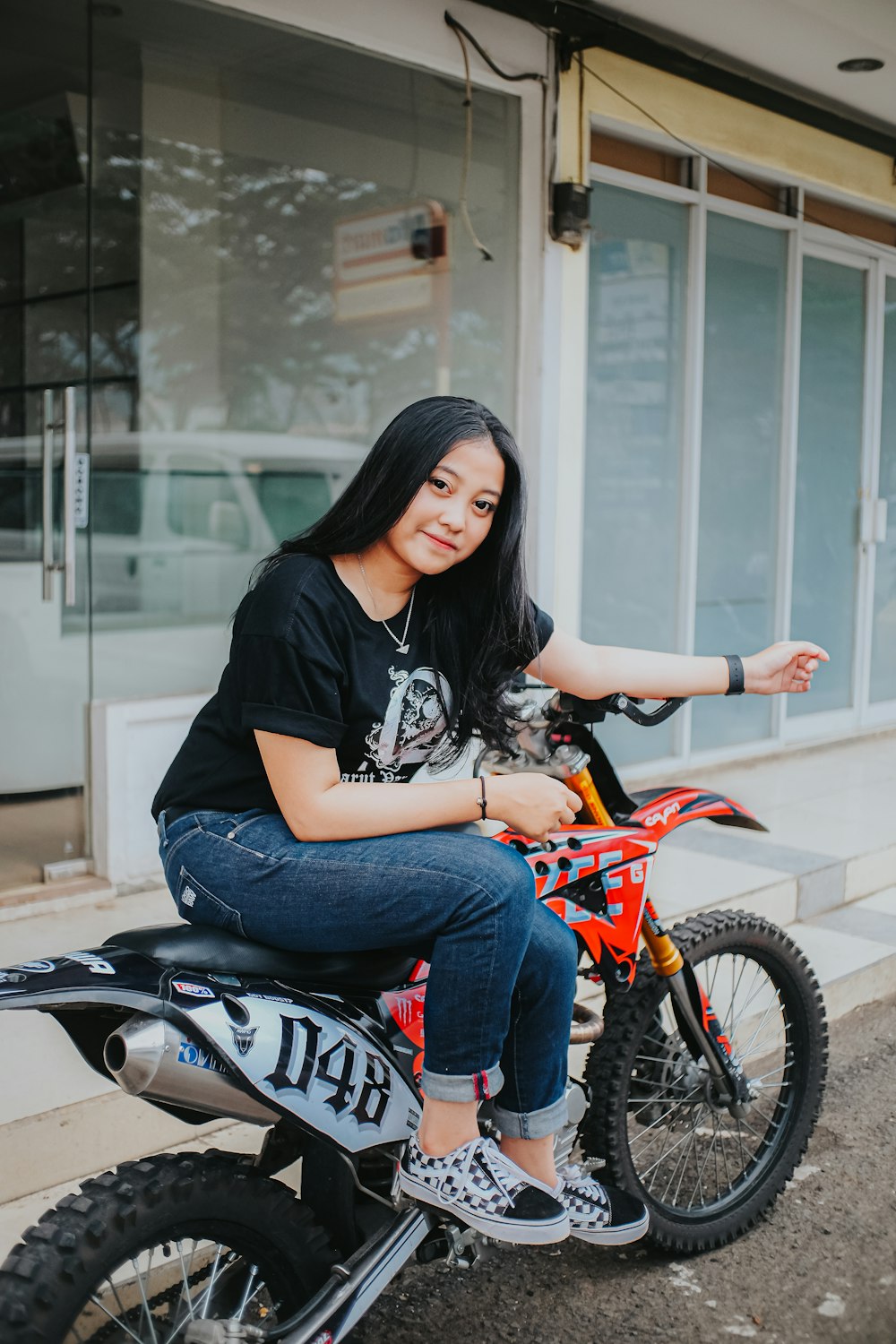 a woman sitting on top of a dirt bike