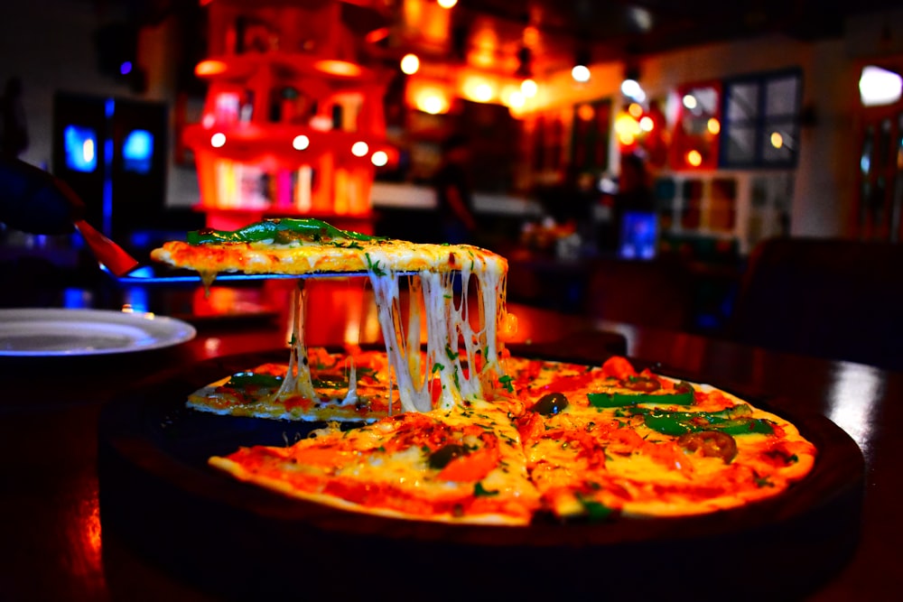 a pizza sitting on top of a wooden table