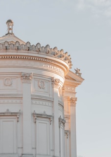 a white building with a clock on the top of it
