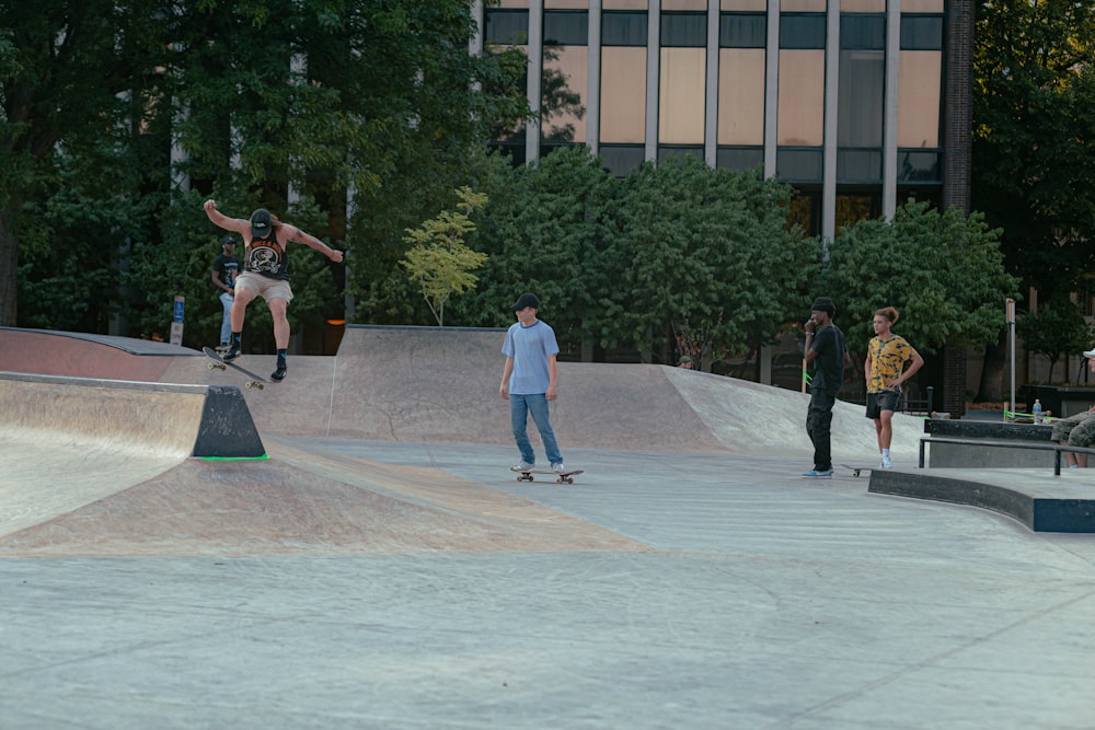 a group of young men riding skateboards at a skate park