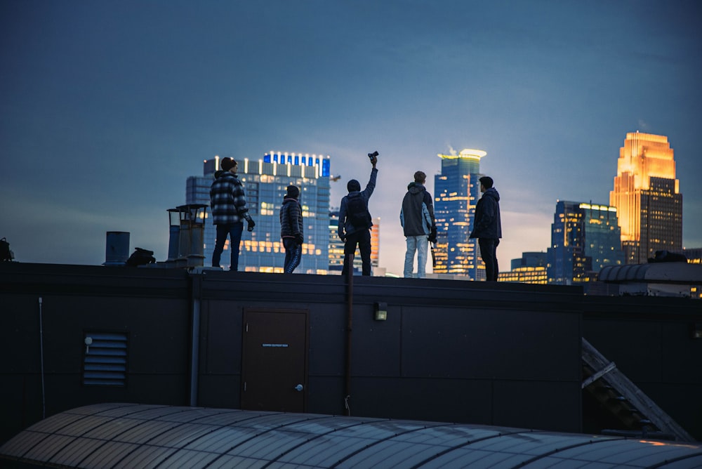 a group of people standing on top of a roof