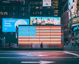 an american flag is projected on a billboard in times square