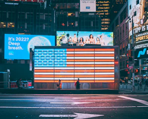 an american flag is projected on a billboard in times square