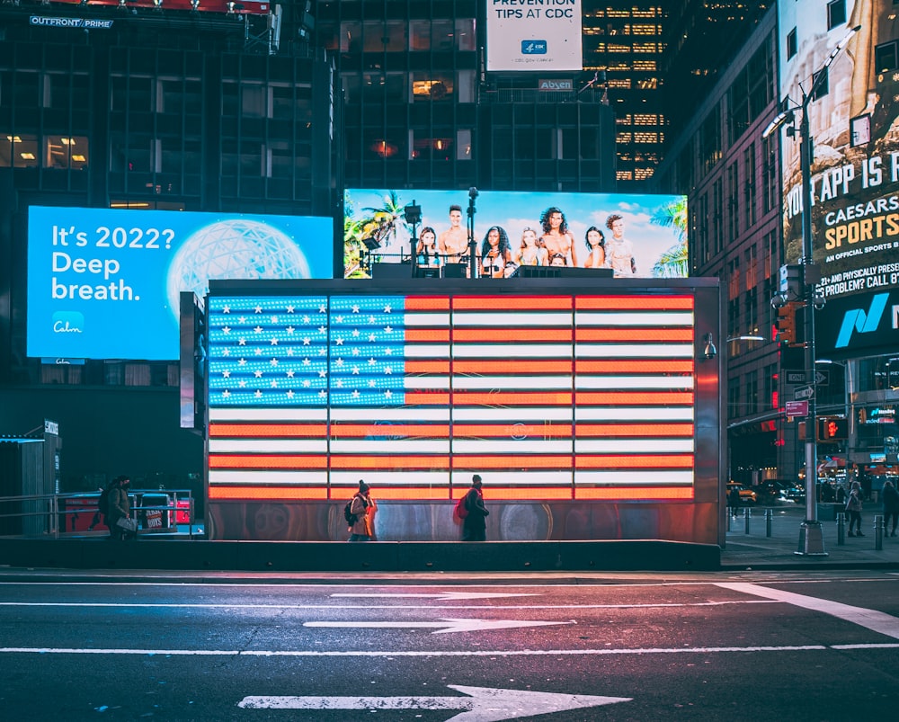Un drapeau américain est projeté sur un panneau d’affichage à Times Square