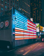 a large american flag is projected on the side of a building