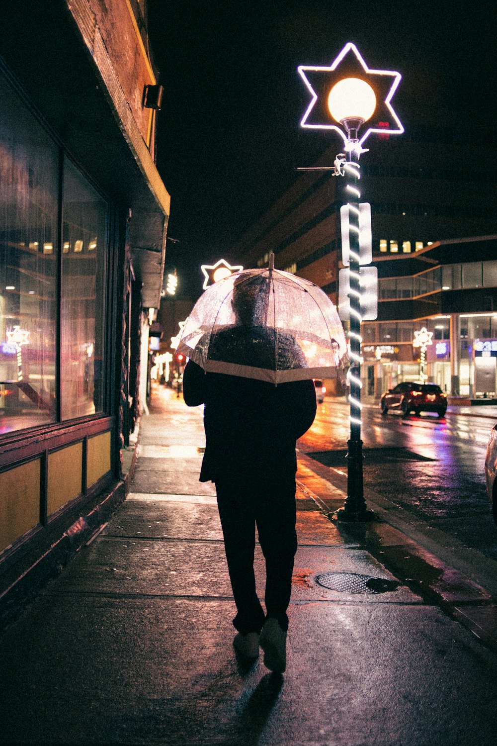 a person walking down a street holding an umbrella