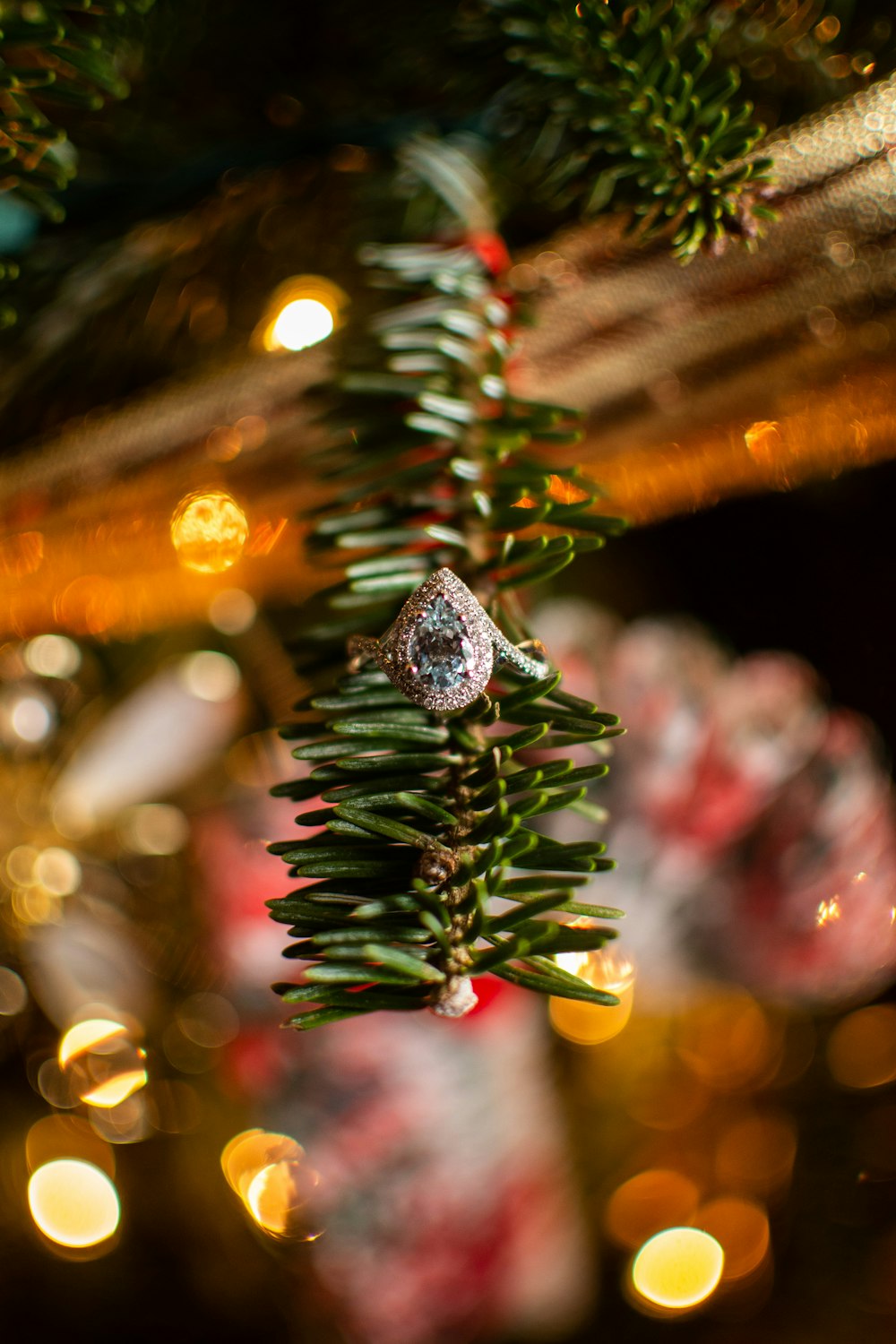 a close up of a christmas tree with lights in the background