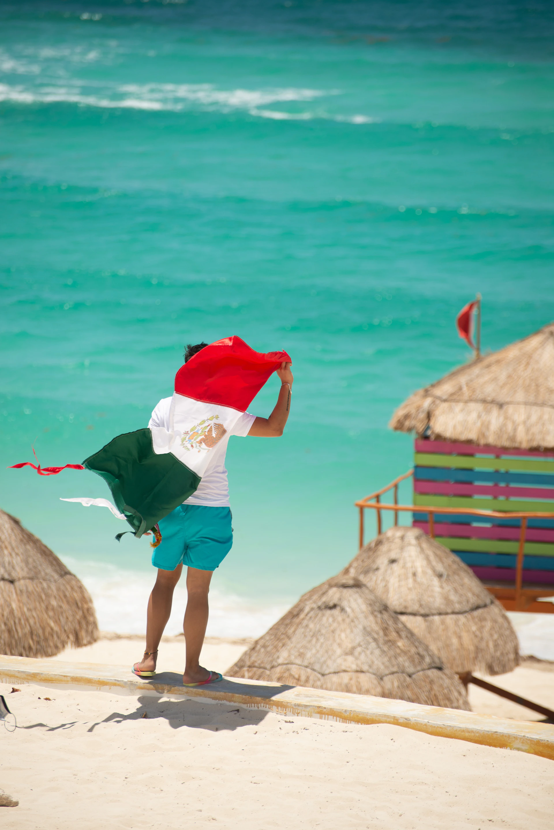 a person on a beach flying a kite
