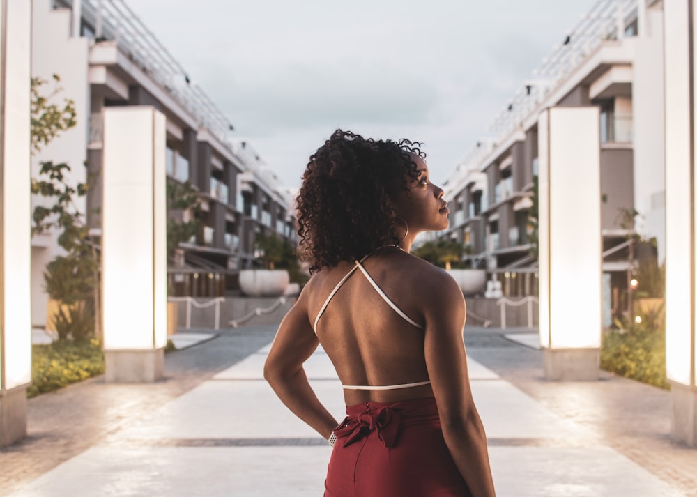 a woman standing in front of a building with her back to the camera