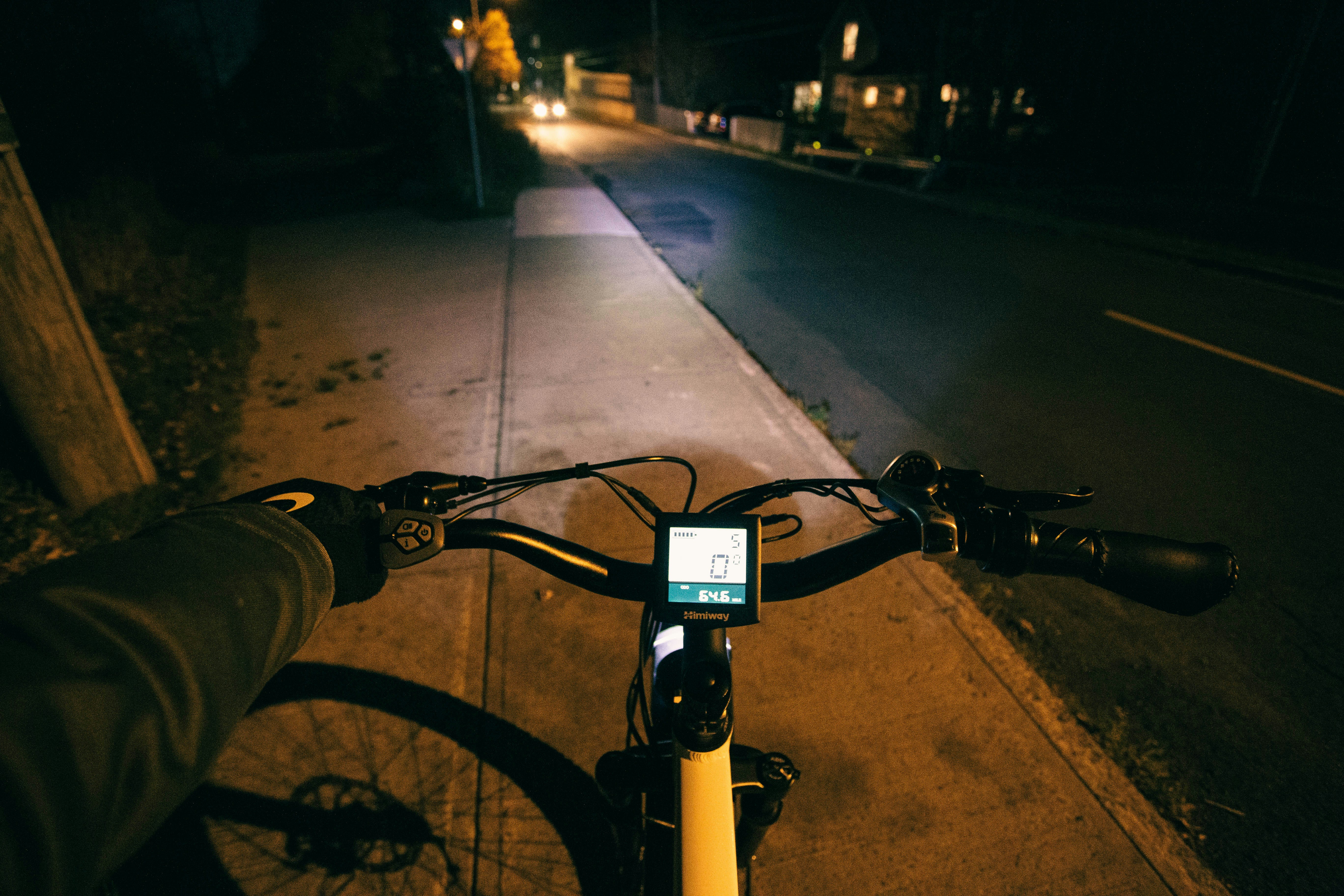Person riding a bike down a street at night