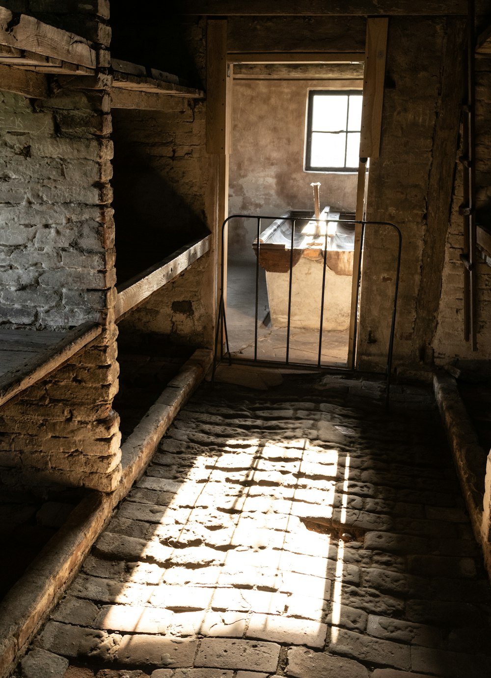 a jail cell with a window and bars