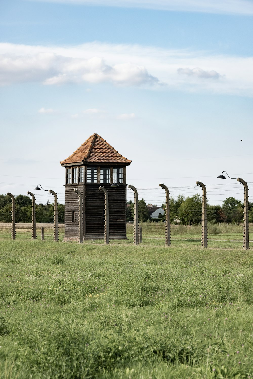 a small wooden structure in a grassy field