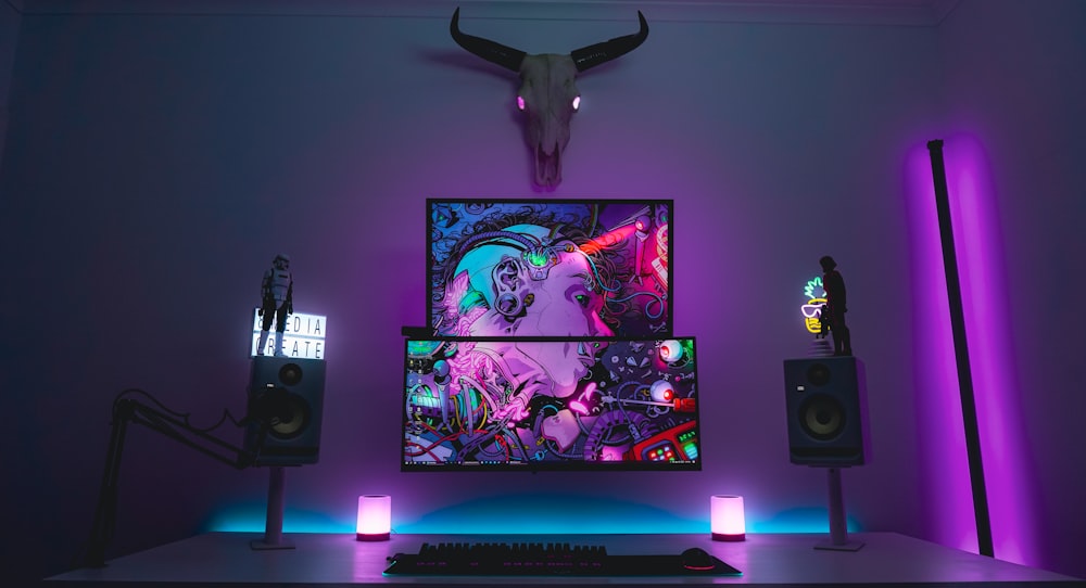 a desk with a monitor and speakers on it