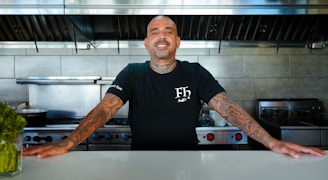 a man standing in front of a counter in a kitchen