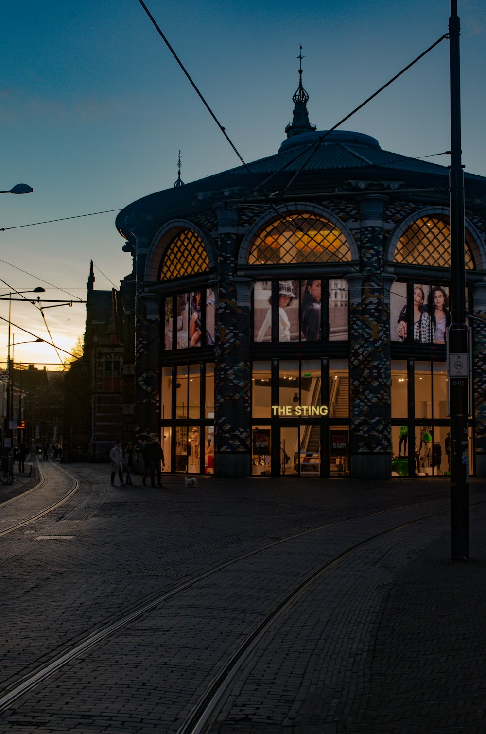 a train station with a train on the tracks in front of it