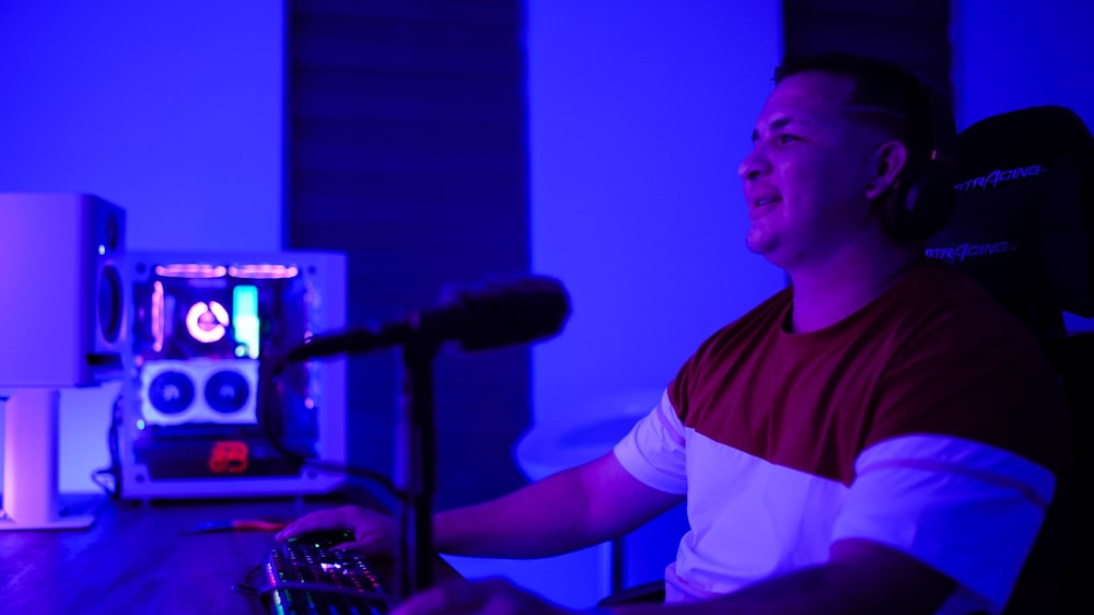 a man sitting in a chair in front of a microphone