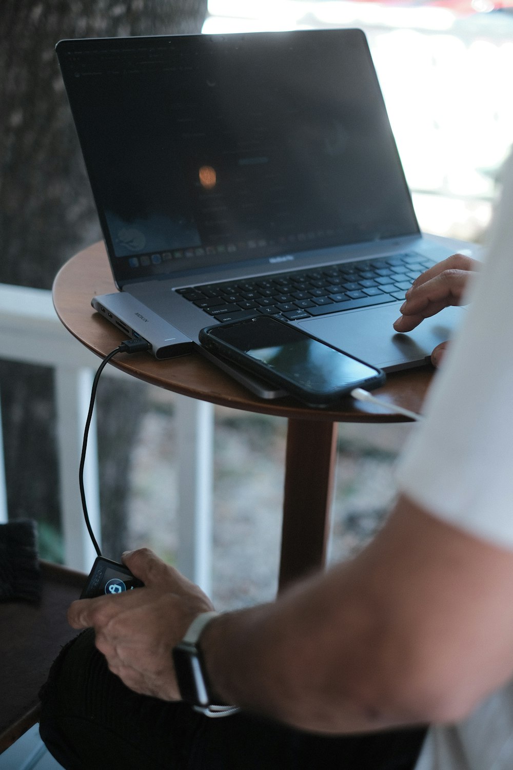 Ein Mann sitzt an einem Tisch mit einem Laptop