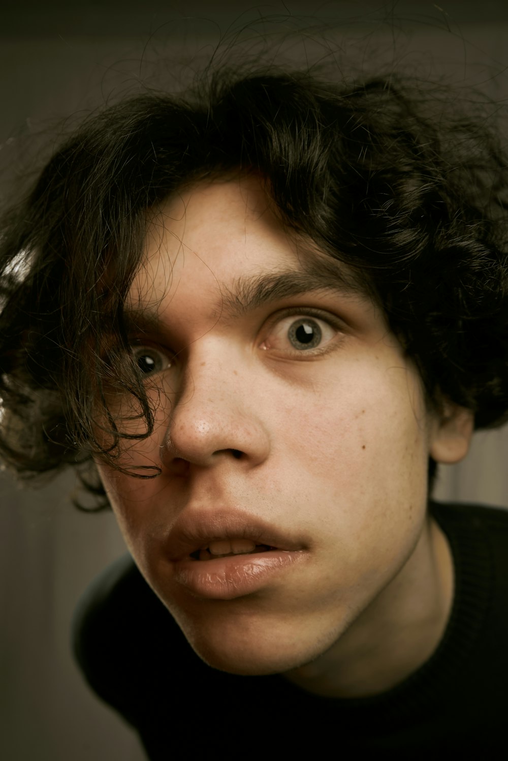 a close up of a person with curly hair