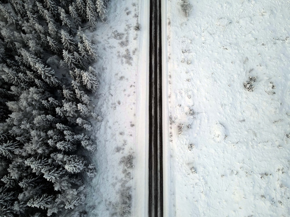 an aerial view of a road in the snow