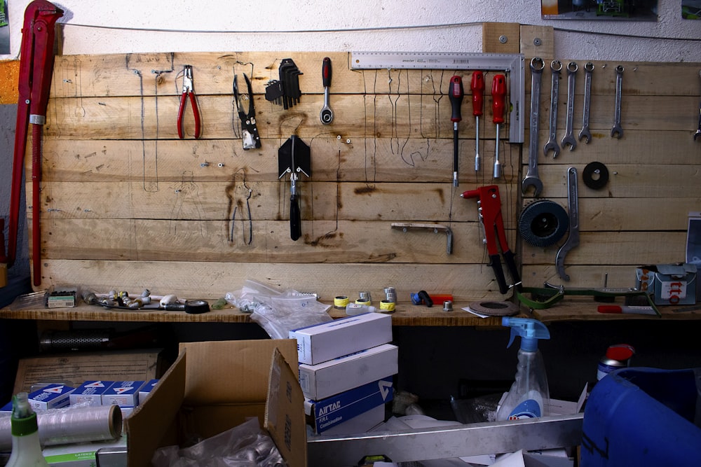 a workbench with tools hanging on the wall