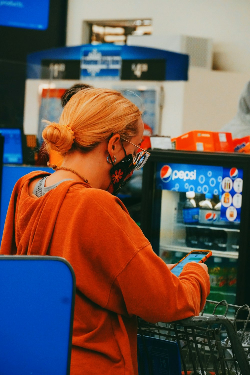 a woman wearing a face mask while shopping in a store