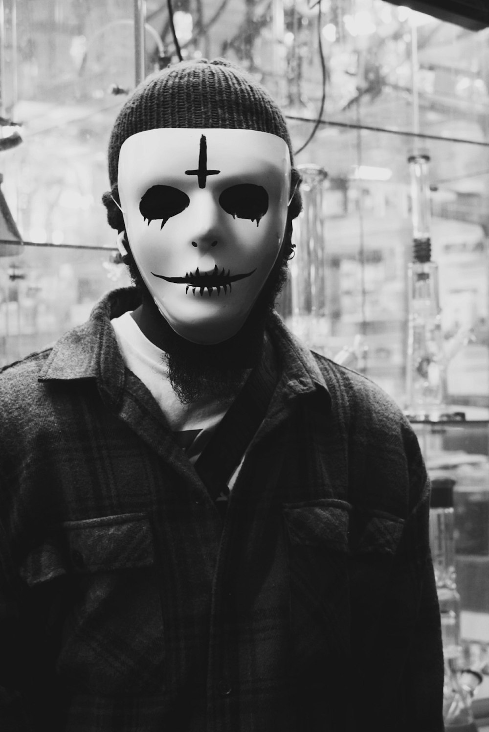 a man wearing a mask with a cross painted on it