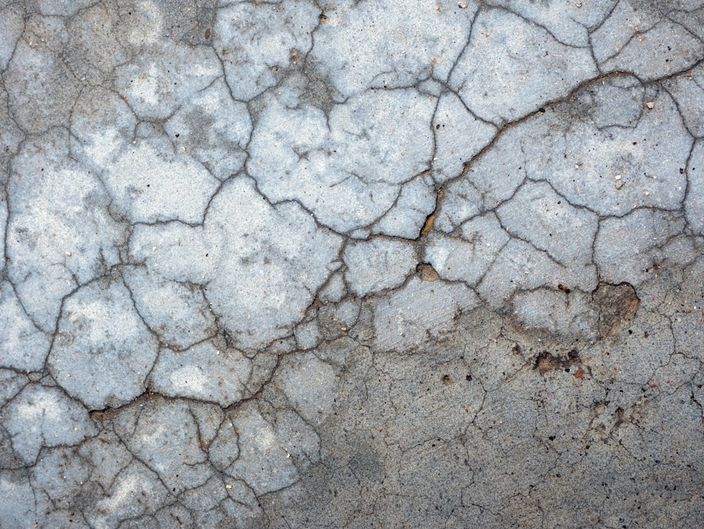 a close up of a cracked concrete surface