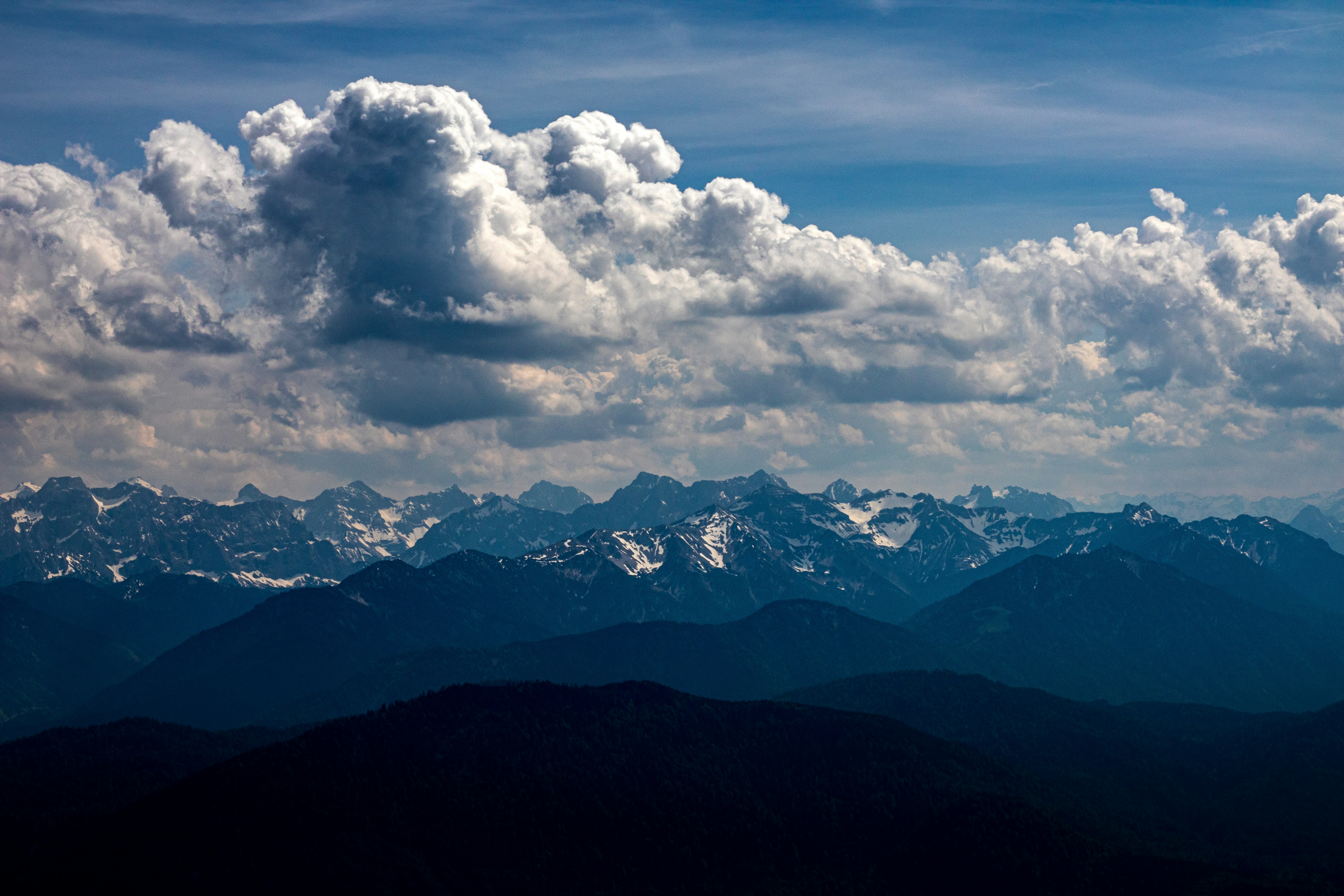 view of clouds and a mountain in the background