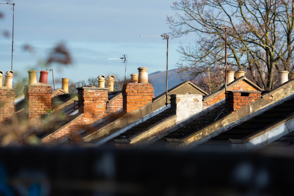 a row of chimneys on top of a brick building